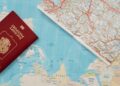 Flat lay of a passport and map, symbolizing travel adventure and exploration.
