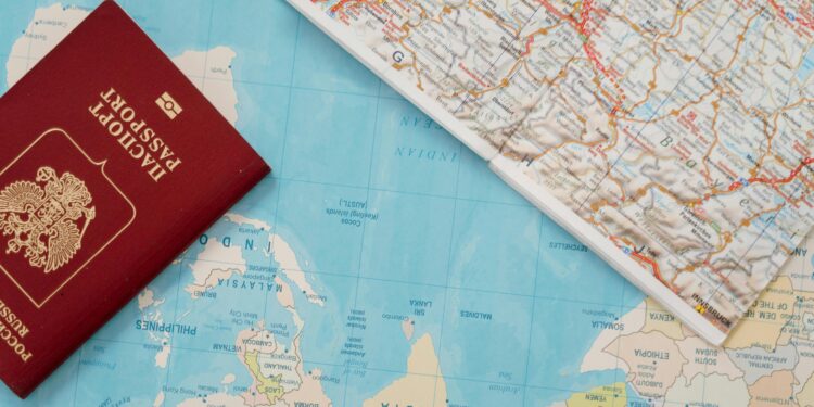 Flat lay of a passport and map, symbolizing travel adventure and exploration.
