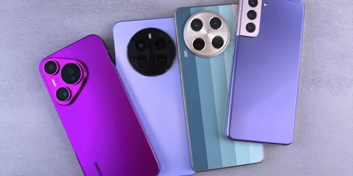 Array of colorful modern smartphones displayed on a grey surface.